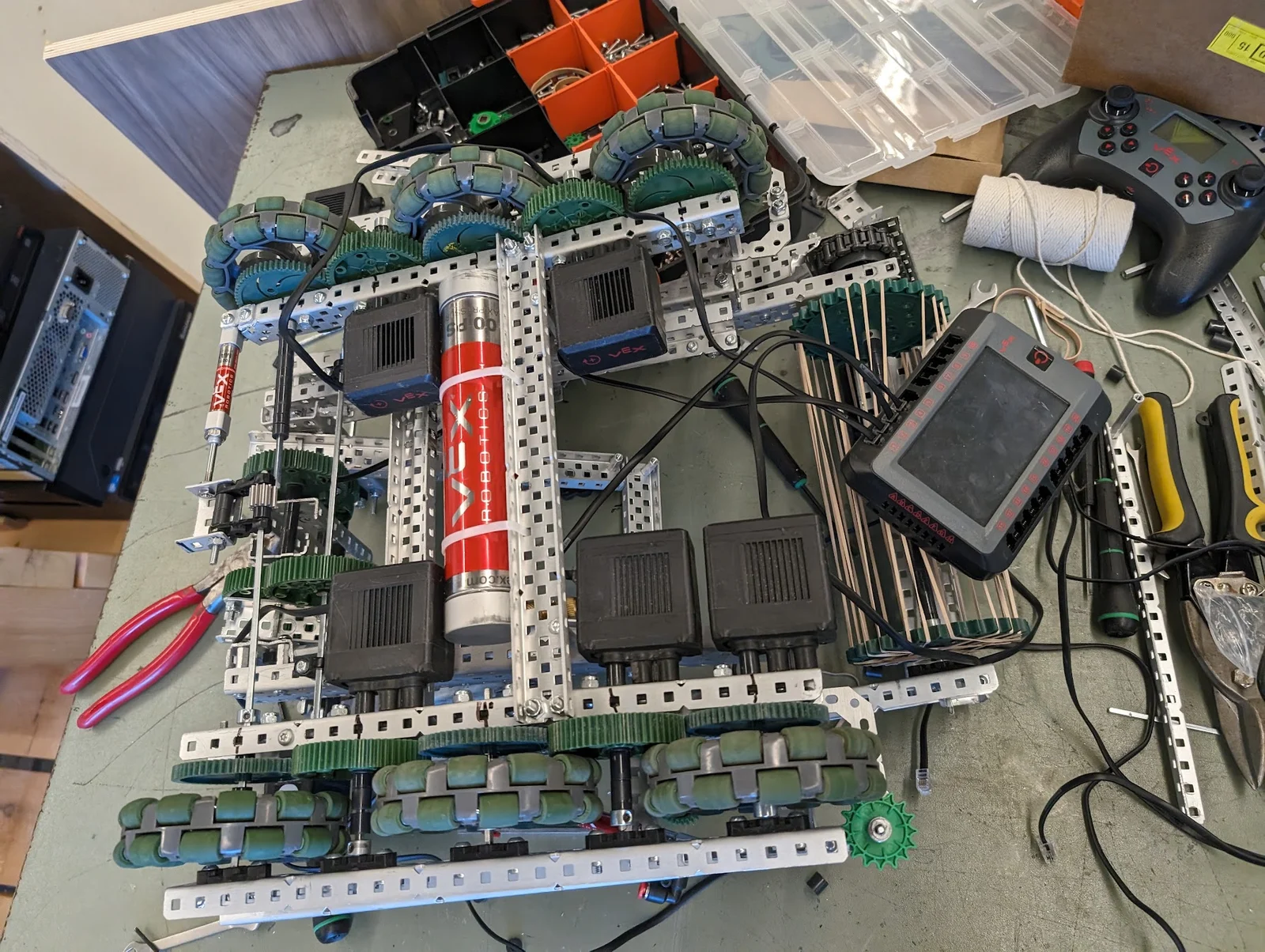 VEX robot on the workbench, showing the drive wheels, gears, and pneumatics